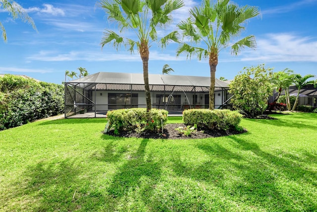 back of house featuring a yard and a lanai