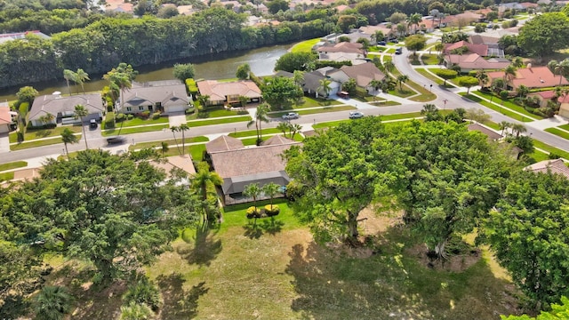 birds eye view of property with a water view and a residential view