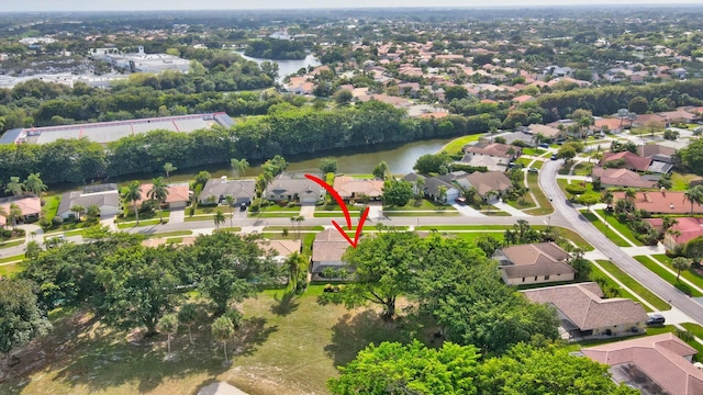 birds eye view of property with a residential view and a water view