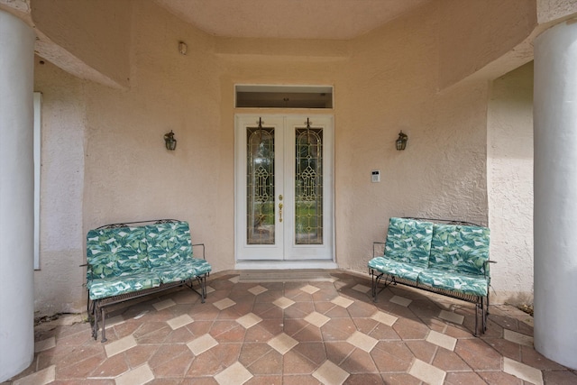 2891 SE Tailwinds Rd, Jupiter, FL 33478 - property entrance featuring french doors, stucco siding, and a patio area
