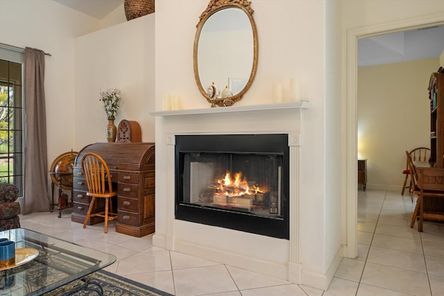 2891 SE Tailwinds Rd, Jupiter, FL 33478 - tiled living area with a lit fireplace and baseboards