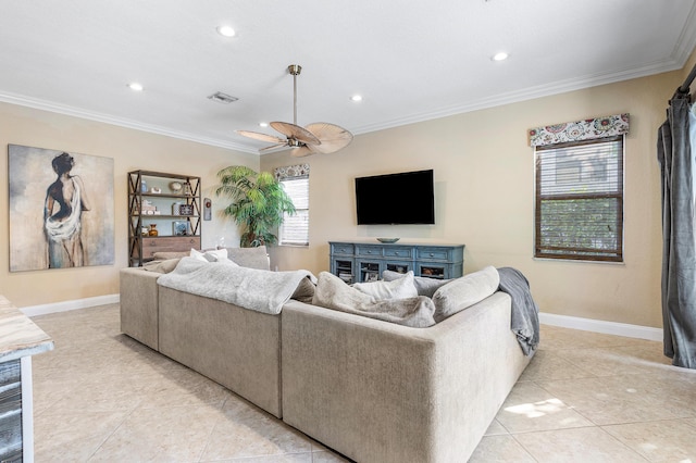 living area with baseboards, a wealth of natural light, and crown molding