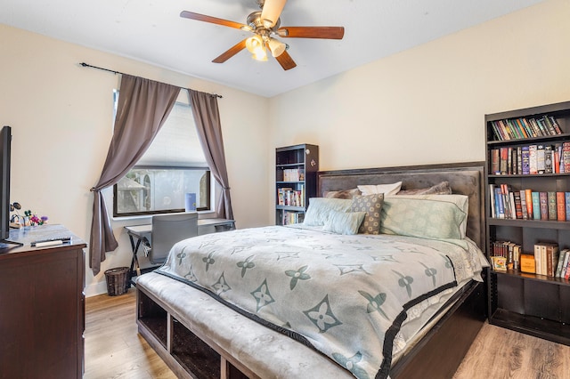 bedroom featuring wood finished floors, a ceiling fan, and baseboards