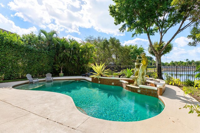 view of swimming pool featuring a patio area, a fenced backyard, a fenced in pool, and a water view