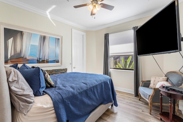 bedroom featuring ceiling fan, a textured ceiling, baseboards, light wood-style floors, and crown molding