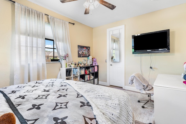 bedroom with ceiling fan and baseboards