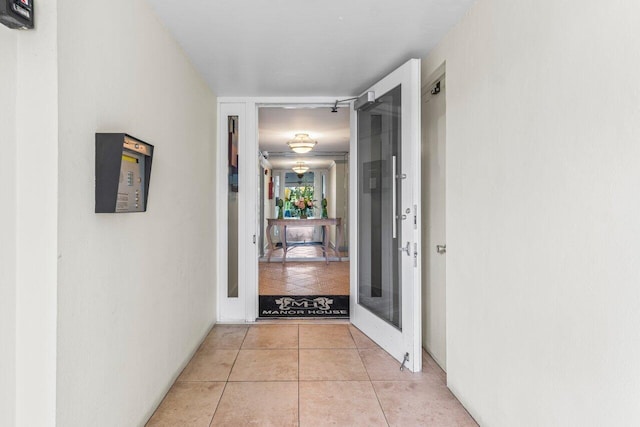 corridor featuring light tile patterned flooring