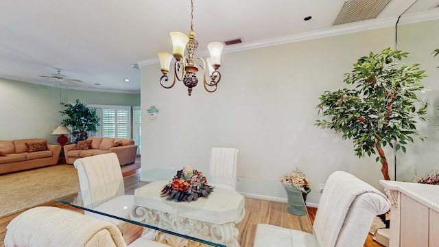 dining area featuring ornamental molding, wood finished floors, and visible vents