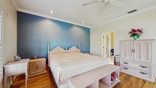 bedroom with recessed lighting, wood finished floors, a ceiling fan, visible vents, and crown molding