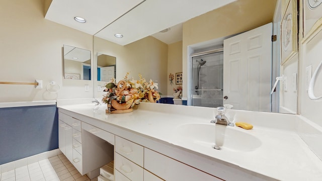 bathroom with a shower with door, double vanity, recessed lighting, a sink, and tile patterned flooring