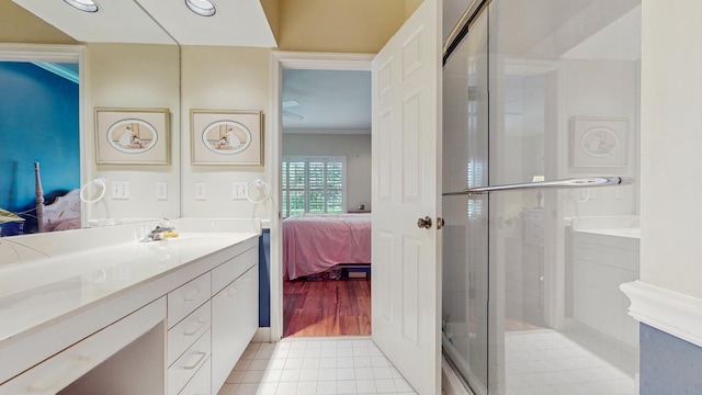 ensuite bathroom featuring ensuite bath, ornamental molding, tile patterned floors, vanity, and a shower stall