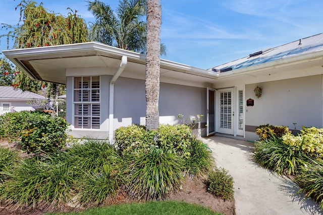 doorway to property with stucco siding