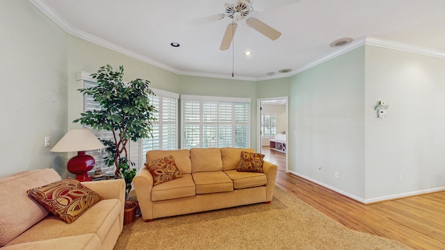 living area featuring recessed lighting, ornamental molding, a ceiling fan, wood finished floors, and baseboards