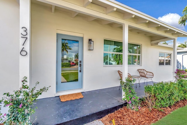 view of exterior entry featuring stucco siding