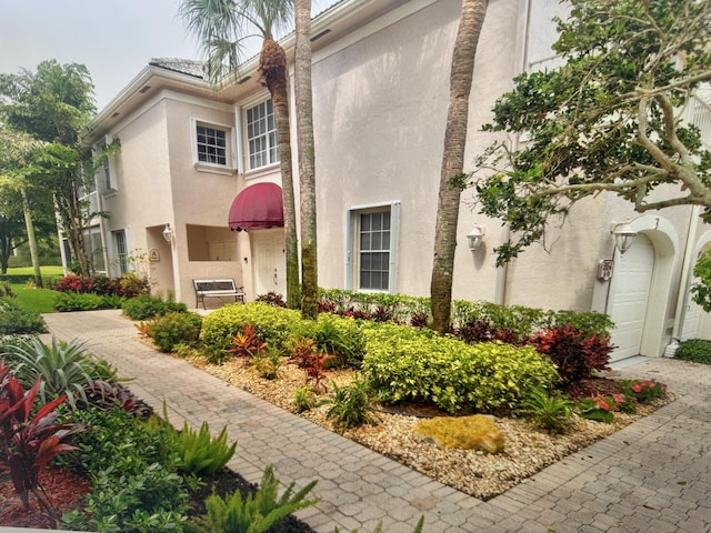 exterior space featuring a garage and stucco siding