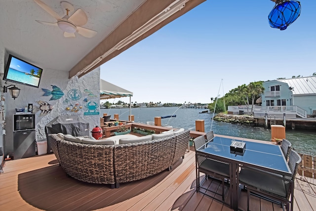 exterior space featuring a water view, an outdoor hangout area, and a ceiling fan