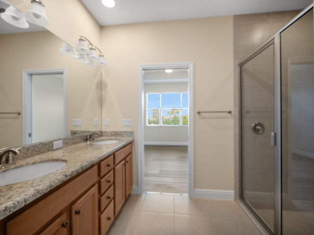 11603 SW Lake Park Dr, Port Saint Lucie, FL 34987 - bathroom featuring a stall shower, tile patterned flooring, a sink, and double vanity