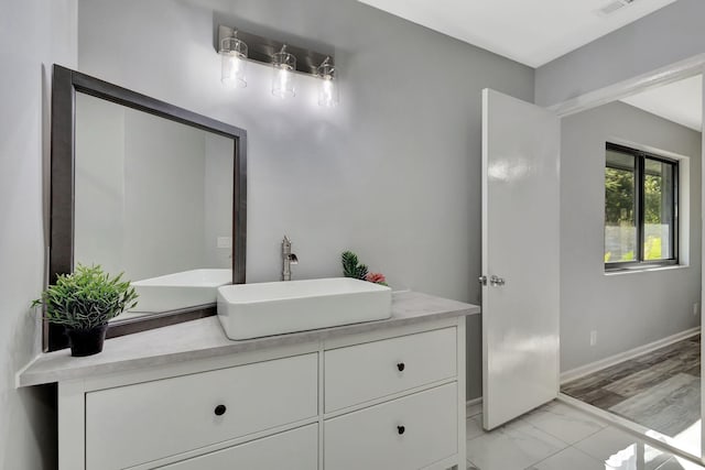 bathroom with visible vents, marble finish floor, vanity, and baseboards