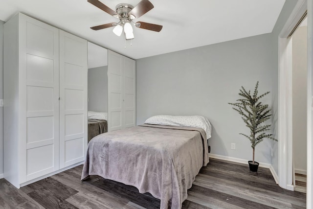 bedroom featuring ceiling fan, baseboards, and dark wood-type flooring