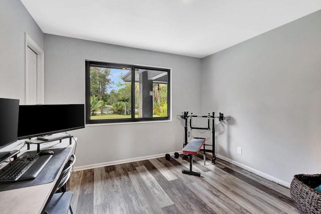 office space with wood finished floors and baseboards