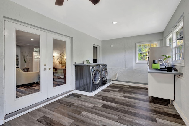 clothes washing area featuring laundry area, baseboards, wood finished floors, washer and dryer, and french doors