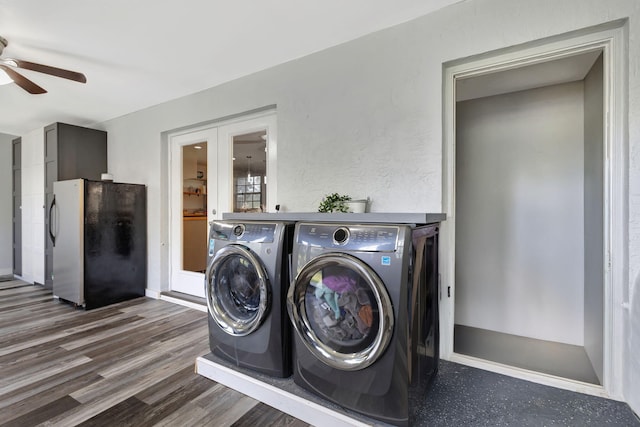 laundry room with washing machine and dryer, a ceiling fan, wood finished floors, and french doors