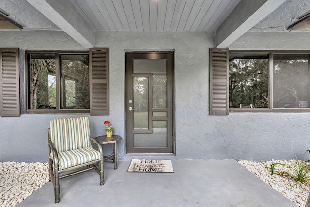 view of exterior entry with stucco siding