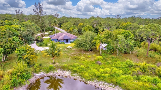 birds eye view of property with a view of trees