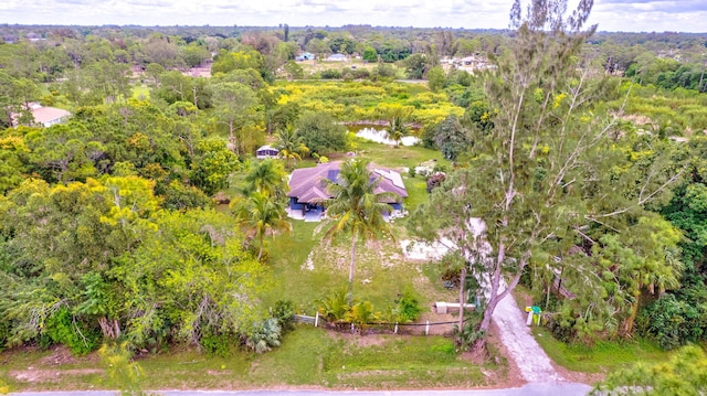 birds eye view of property with a wooded view