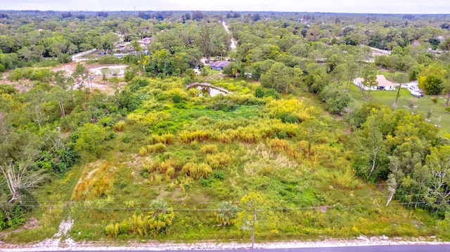 birds eye view of property featuring a wooded view