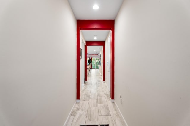 hall featuring baseboards