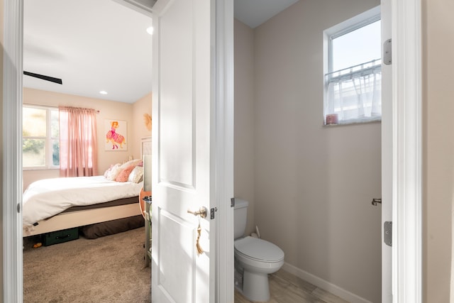 bathroom with toilet, baseboards, and recessed lighting