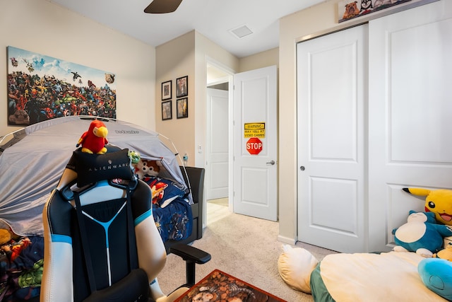 bedroom featuring a closet and light colored carpet