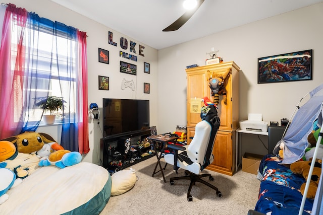 bedroom with a ceiling fan and light carpet