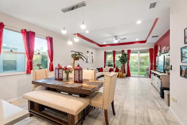 dining area featuring recessed lighting, a raised ceiling, visible vents, and baseboards