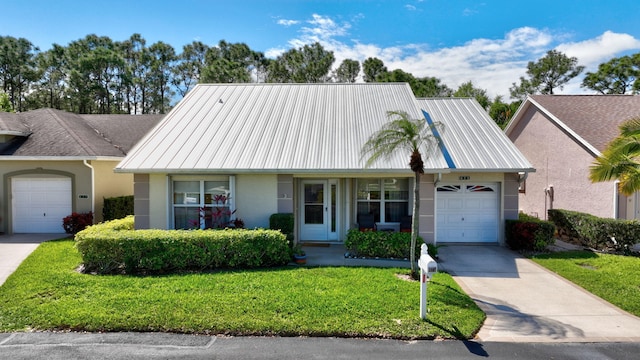 view of front facade with a garage, metal roof, concrete driveway, and stucco siding