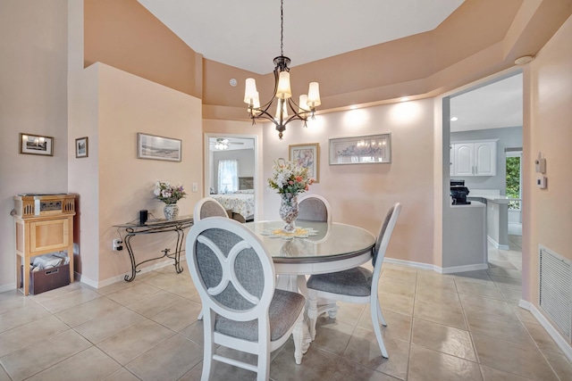 dining room with light tile patterned floors, a notable chandelier, visible vents, and baseboards