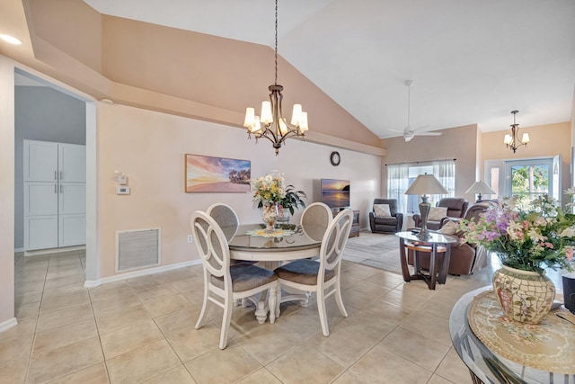 dining area with high vaulted ceiling, light tile patterned flooring, visible vents, and baseboards