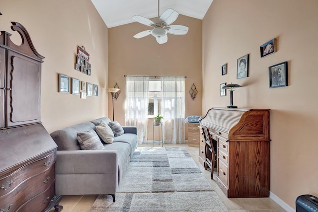 living area with light tile patterned floors, baseboards, high vaulted ceiling, and a ceiling fan