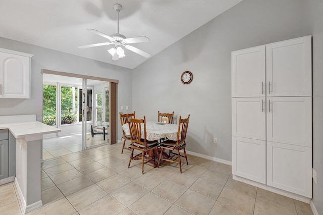 dining area with ceiling fan, high vaulted ceiling, light tile patterned flooring, and baseboards