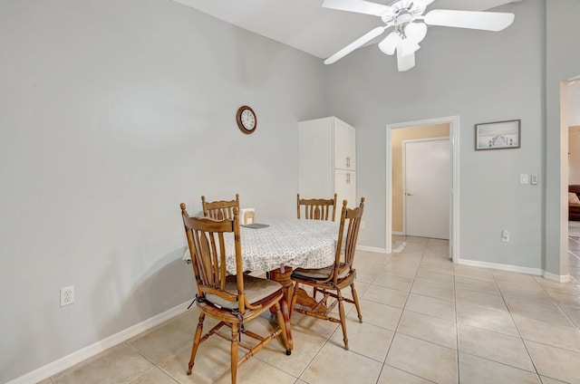 dining space featuring light tile patterned flooring, ceiling fan, and baseboards