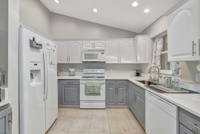 kitchen with white appliances, white cabinets, light countertops, gray cabinetry, and a sink