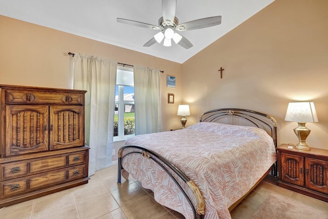 bedroom with vaulted ceiling, ceiling fan, and light tile patterned flooring