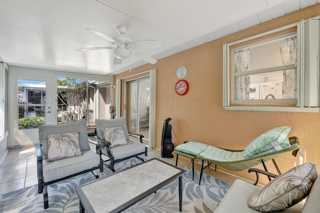 sunroom / solarium featuring ceiling fan