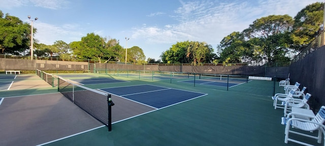 view of tennis court featuring fence