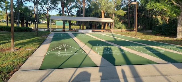 surrounding community featuring shuffleboard and a lawn