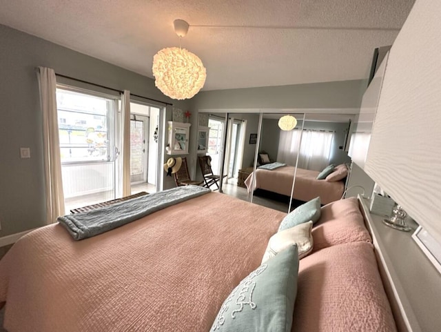 bedroom featuring access to outside, vaulted ceiling, a textured ceiling, and baseboards