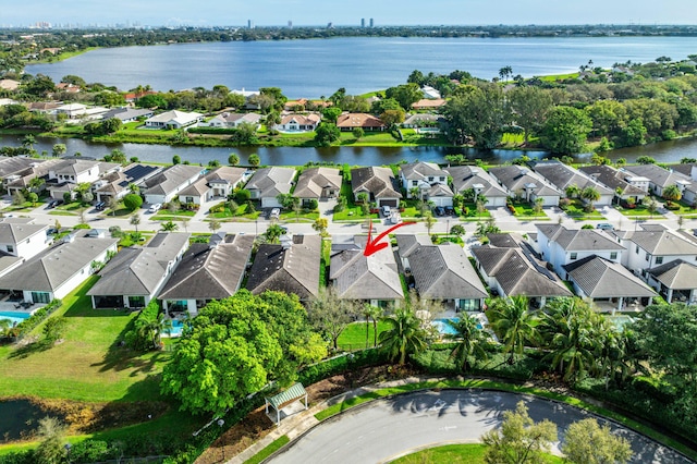 birds eye view of property with a residential view and a water view