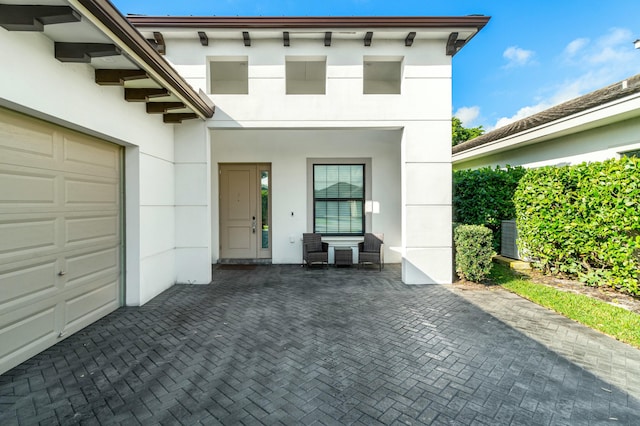 view of front of house with a garage and stucco siding