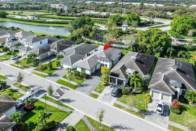 bird's eye view with a residential view and a water view